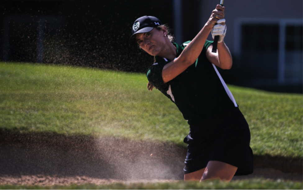 woman hitting golf ball out of sand trap