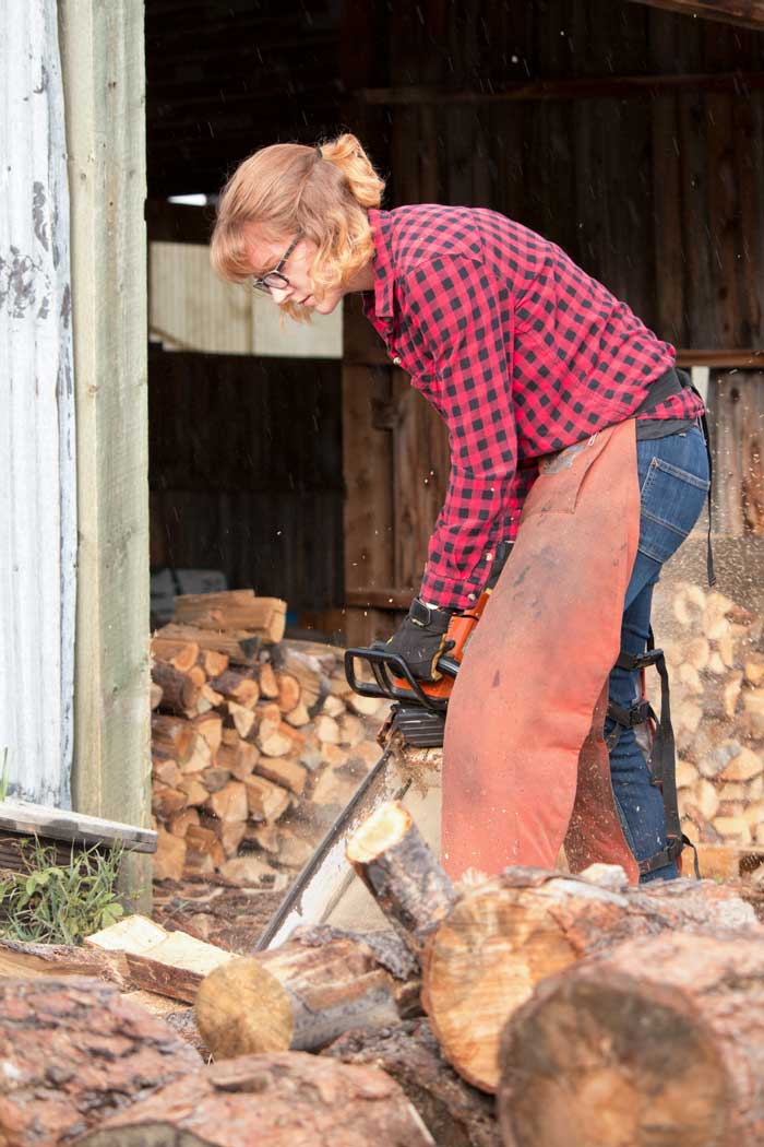 Lauren Domnik cutting firewood