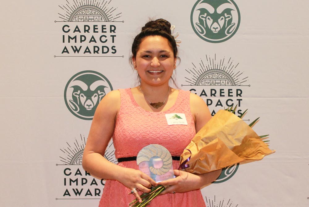 woman smiling with award