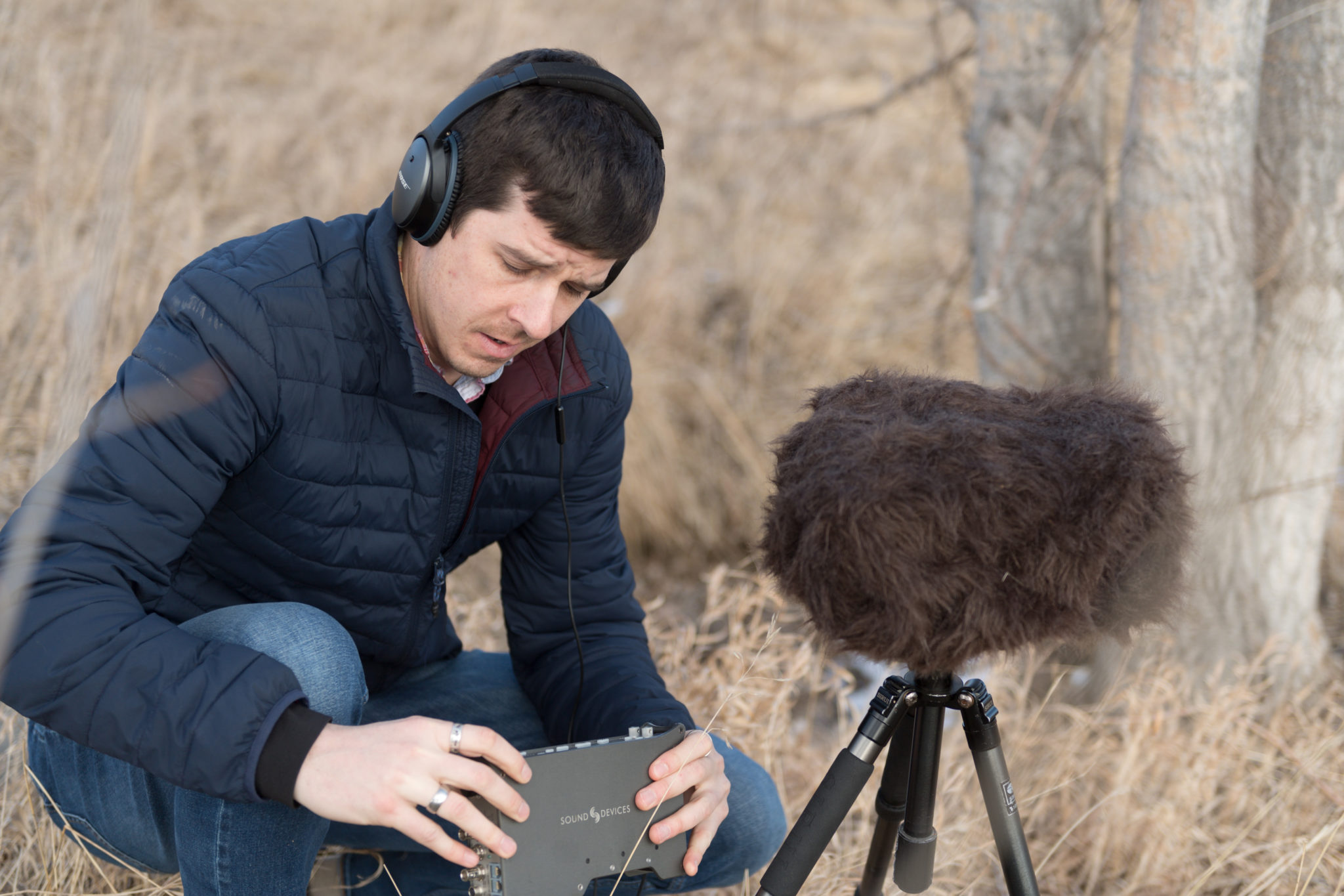 Jacob Job looks at his recording equipment while out in the field