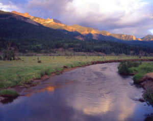 close-up of a stream on Banded Peak Ranch, with mountains in the background