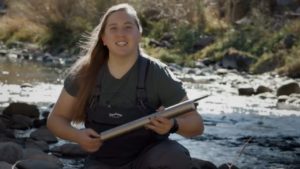 Schmer displays a probe used to collect water measurements along the Poudre River. Photo: screenshot by author from CSU online video