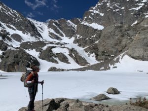 WCNR master's student Caitlin Charlton at Sky Pond, the alpine lake in the Loch Vale Watershed, in early summer before the lake has iced off.