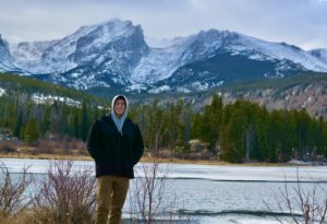 . Diego Tovar in Rocky Mountain National Park with a mountain behind him.