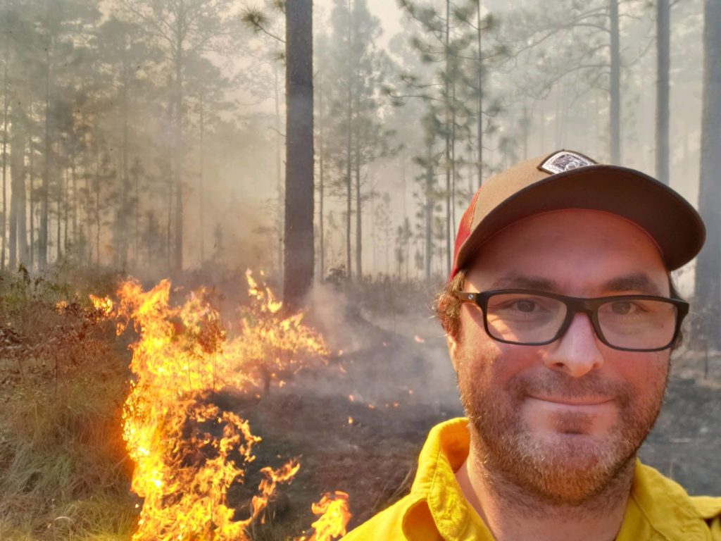 man in front of fire line