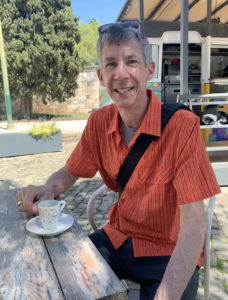 Czaja sitting with coffee in Belem, Portugal