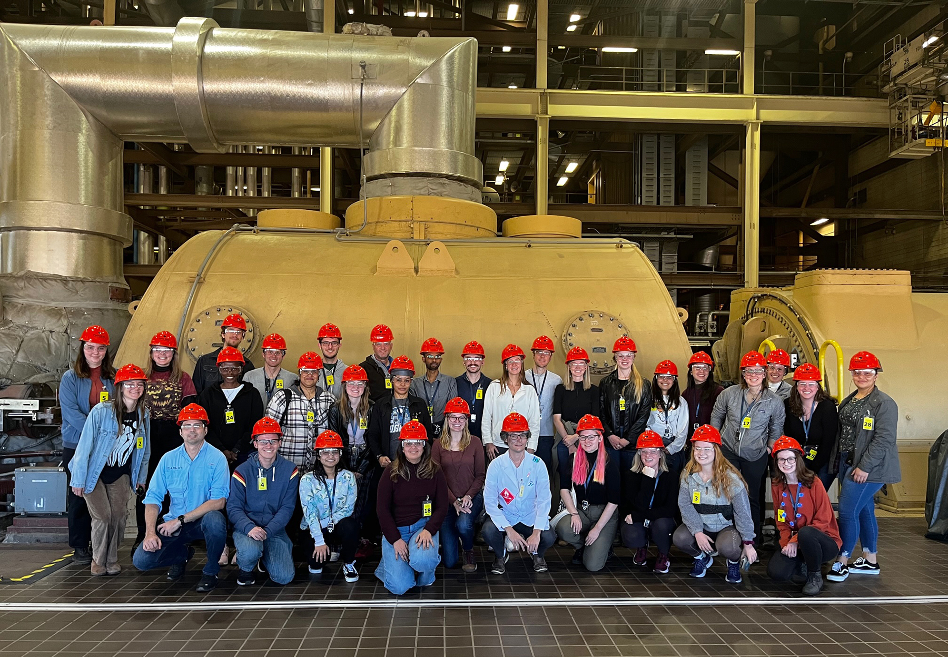 Students pose in front of a tank on a field trip to the Rawhide Energy Station