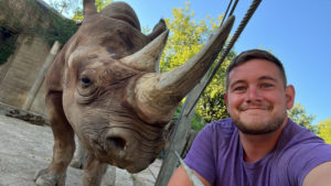Ben and a black rhino at the Denver Zoo.